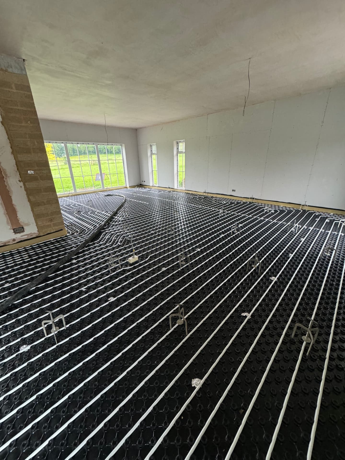 Underfloor heating pipework installed across a large open-plan room